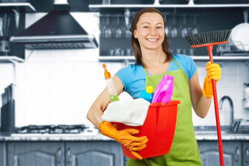 Local oven cleaner working in a Chelsea apartment kitchen